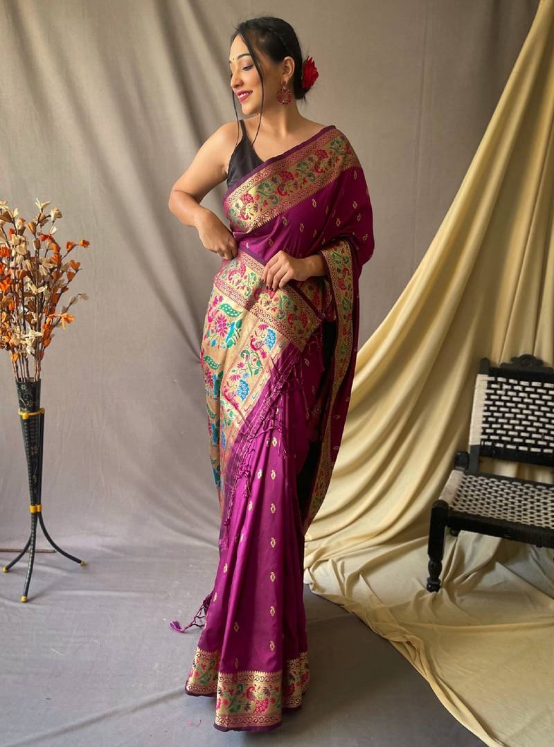 Purple paithani woven design saree and has a zari border blouse piece