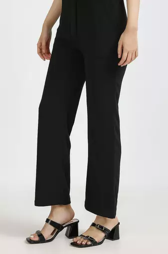 women solid black regular fit mid-rise flat front trousers