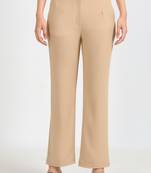 Women solid beige regular fit mid-rise flat front trousers
