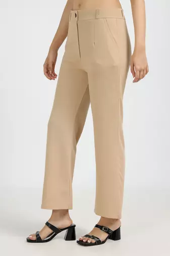 women solid beige regular fit mid-rise flat front trousers