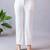 Women solid white regular fit mid-rise flat front trousers