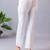 Women solid white regular fit mid-rise flat front trousers