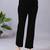 Women solid black regular fit mid-rise flat front trousers