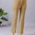 Women solid beige regular fit mid-rise flat front trousers