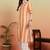 Women's cotton crape calf length strip print half length sleeve v-neck straight kurta (orange )
