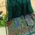 Dark green color pure zari and meena weaving linen silk saree