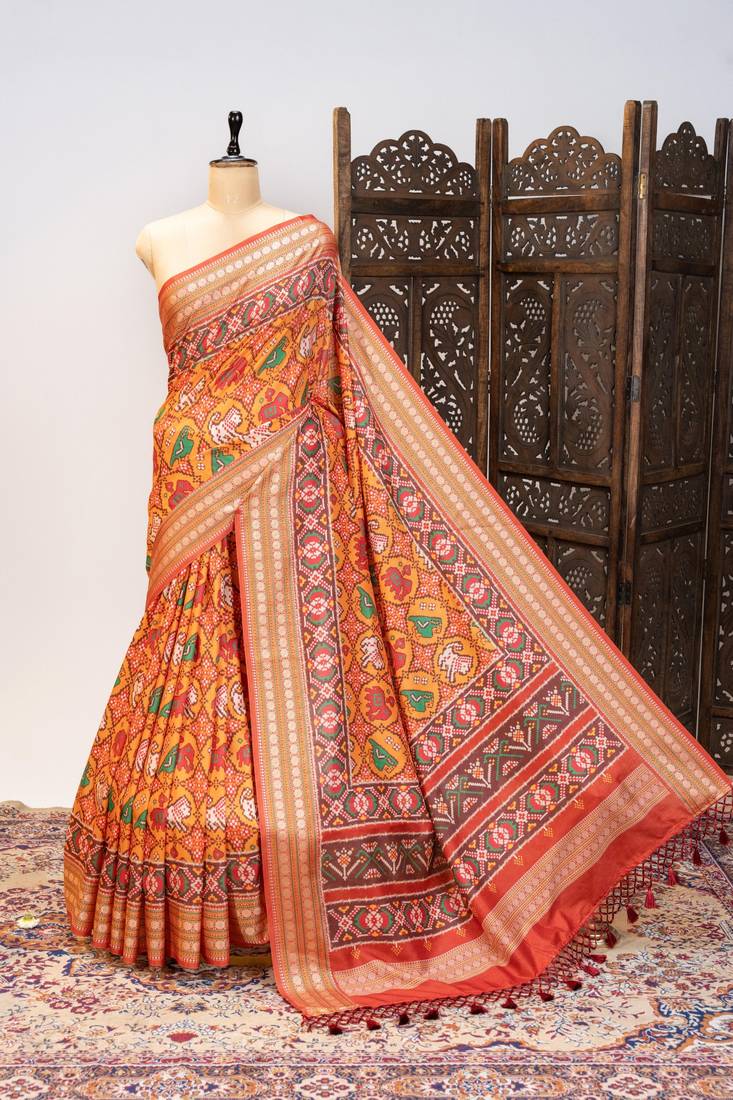 Orange color patola design and silver coin weaving pure patola silk saree