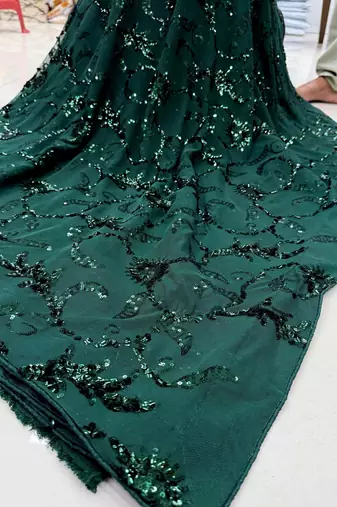 Dark green net embroidered saree