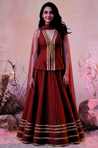 rust orange lace work traditional lehenga with deep v neck long blouse