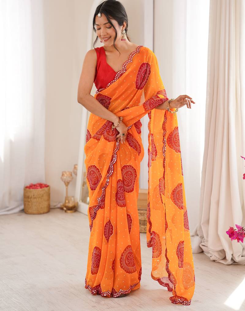 Orange color faux georgette bandhani printed traditional festive saree
