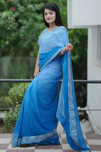 Blue faux georgette padding saree with smart and trendy mirror work