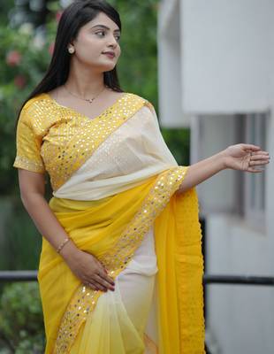 Yellow faux georgette padding saree with smart and trendy mirror work 3