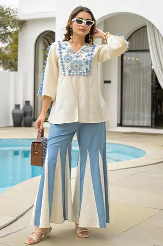 Women's cream rayon embroidered v-neck luxury kurta set with aqua palazzo