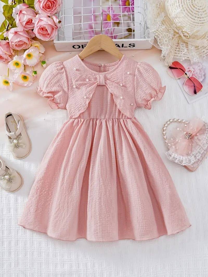 Peach embellished textured fabric bow style girls dress