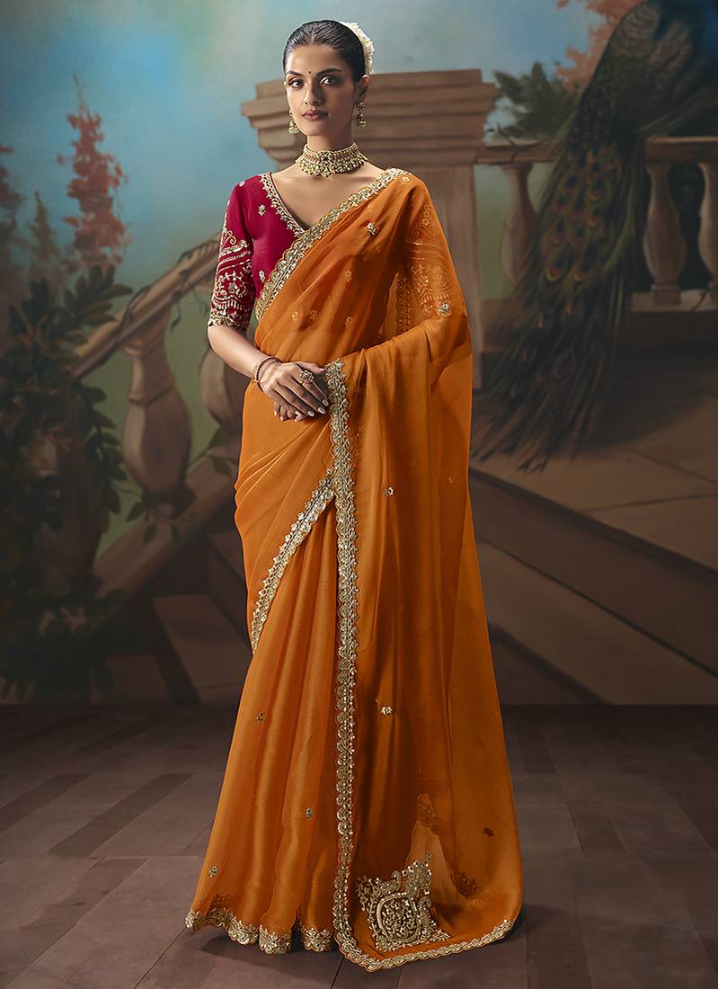 Orange fancy fabric saree with embroidered work