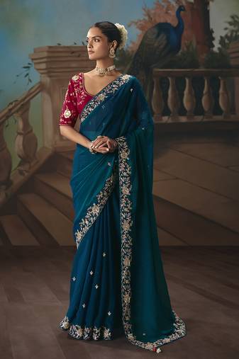 Teal blue fancy fabric saree with embroidered work