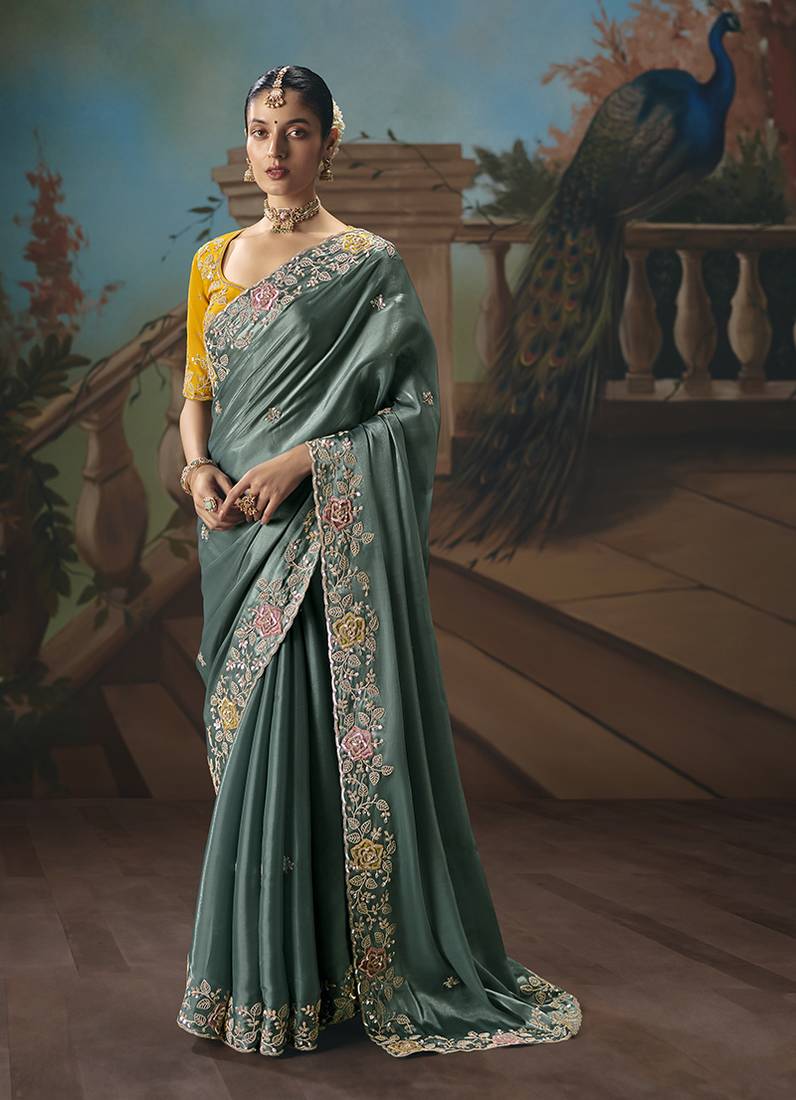 Teal fancy fabric saree with embroidered work