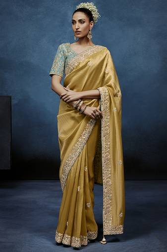 Gold fancy fabric embroidered saree with stiched blouse