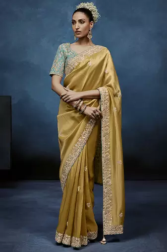 Gold fancy fabric embroidered saree with stiched blouse