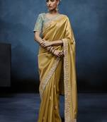Gold fancy fabric embroidered saree with stiched blouse
