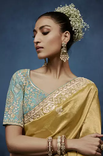 Gold fancy fabric embroidered saree with stiched blouse