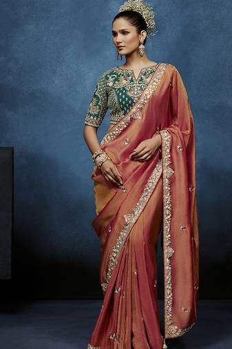 Rust fancy fabric embroidered saree with stiched blouse