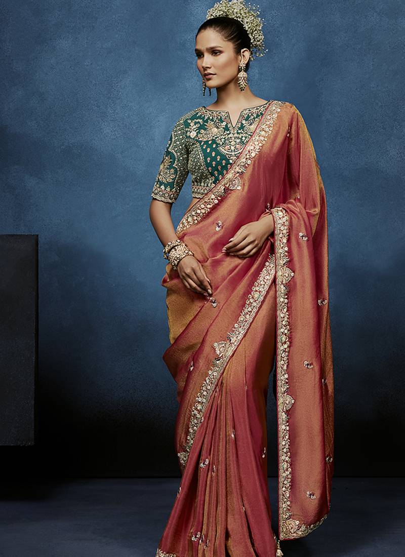 Rust fancy fabric embroidered saree with stiched blouse