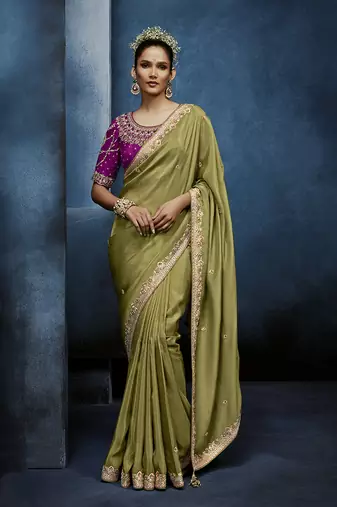 Light green fancy fabric embroidered saree with stiched blouse