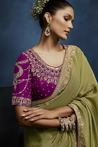 Light green fancy fabric embroidered saree with stiched blouse