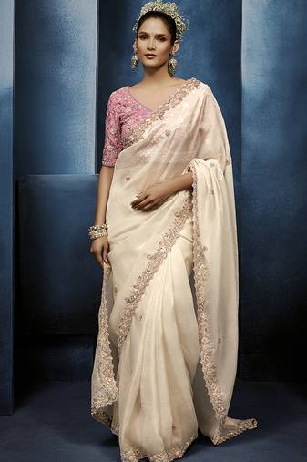 Cream fancy fabric embroidered saree with stiched blouse