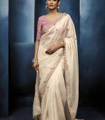 Cream fancy fabric embroidered saree with stiched blouse