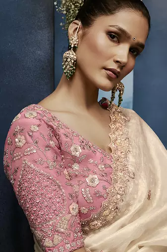 Cream fancy fabric embroidered saree with stiched blouse