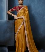Orange fancy fabric embroidered saree with stiched blouse