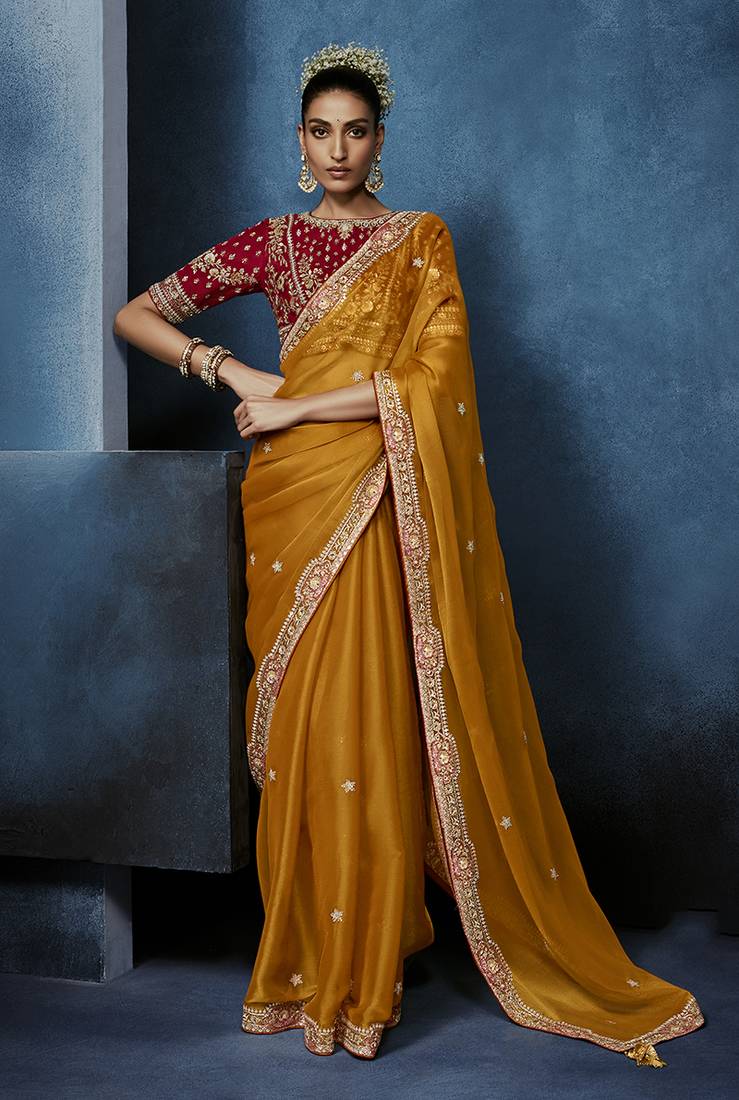 Orange fancy fabric embroidered saree with stiched blouse