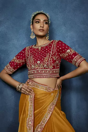 Orange fancy fabric embroidered saree with stiched blouse
