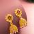  gold plated floral jhumka earrings with pink stone accents