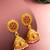  floral motif gold plated pink stone jhumka earrings