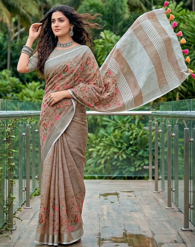 women linen saree with  embroidery and tassel pallu
