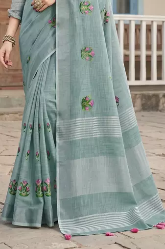 women sea green linen saree with floral embroidery border & tassels