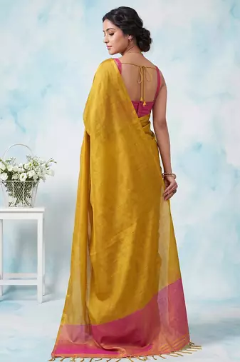 women bright yellow & pink solid tissue silk blend saree with zari border