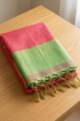 women coral peach & green solid tissue silk blend saree with contrast border
