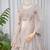 Luxury Beige Net Lehenga Choli with Allover Beads & Dori Embellishment