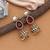 Red color american diamond earrings