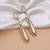 White color matte gold earrings