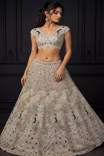White Color Peacock Pattern Crafted,Dori And Thread Work,Zircon Diamond Studded All Over Work Net Lehenga Choli