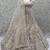 White Peacock Pattern Crafted Dori And Thread Zircon Studded Net Lehenga Choli