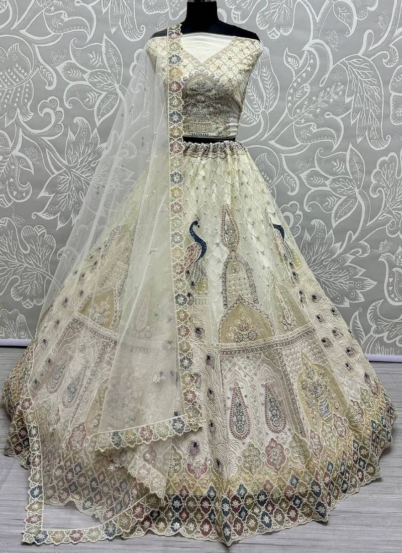 White Color Peacock Pattern Crafted,Dori And Thread Work,Zircon Diamond Studded All Over Work Net Lehenga Choli