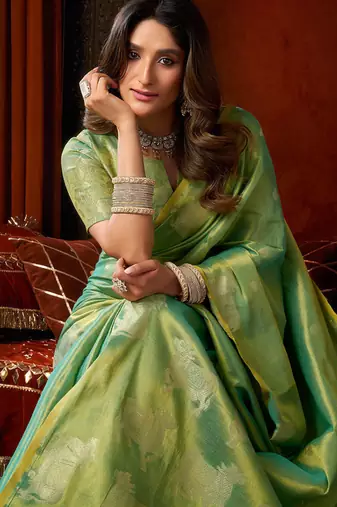 Sea green heavy tissue allover cow woven butta with tassels saree with blouse