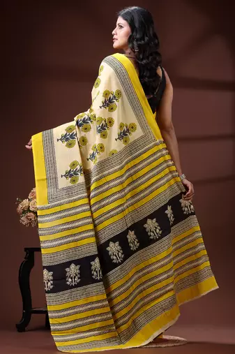 Beige  malmal cotton saree in yellow floral buti print with contrast border