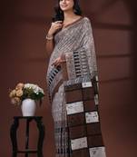 Coffee brown  malmal cotton saree in ethnic batik print with geometric block pallu